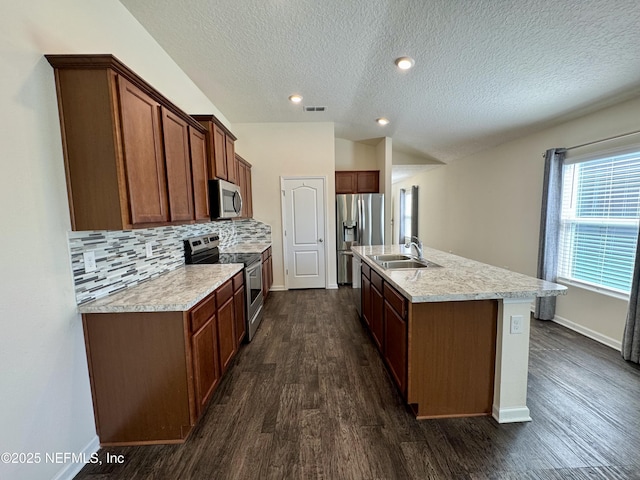 kitchen with visible vents, dark wood-type flooring, backsplash, stainless steel appliances, and light countertops