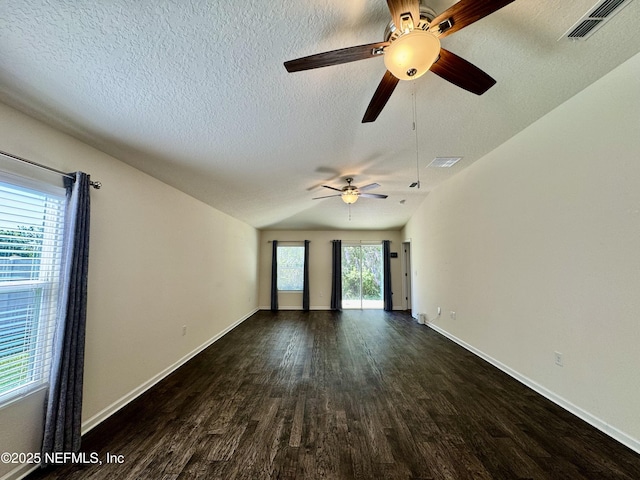 unfurnished room with dark wood finished floors, baseboards, visible vents, and a textured ceiling