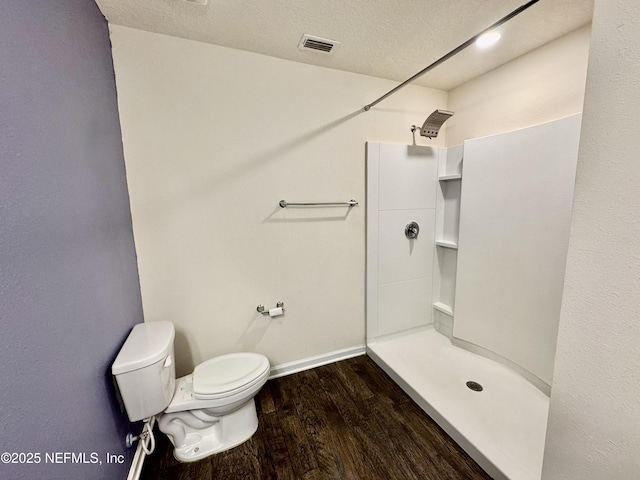 full bath with a shower, visible vents, toilet, and wood finished floors