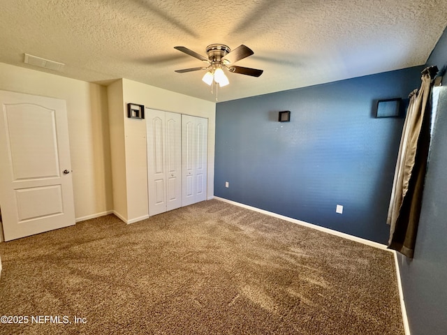 unfurnished bedroom with a ceiling fan, a textured ceiling, a closet, carpet floors, and baseboards