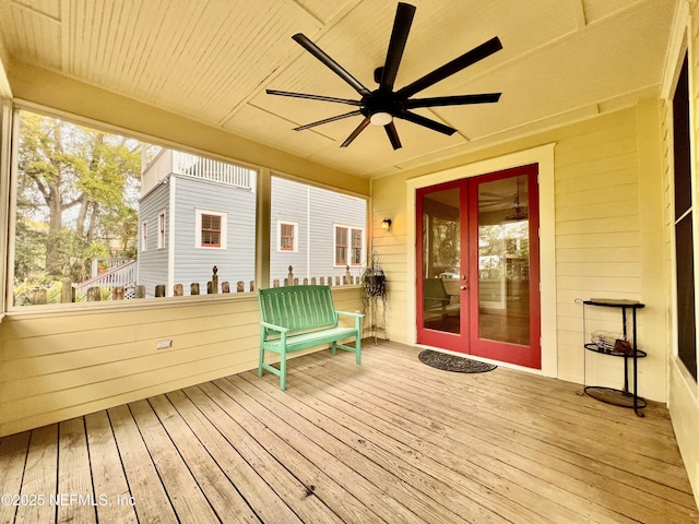 wooden deck with french doors and a ceiling fan