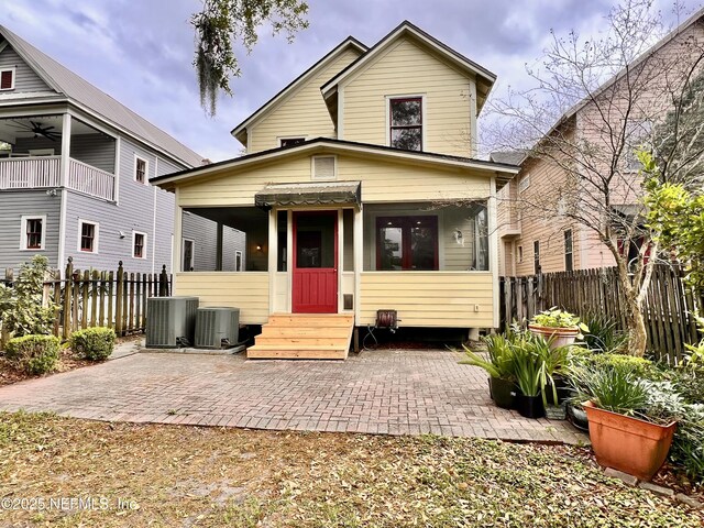 view of front of property featuring entry steps, a patio area, central AC unit, and fence