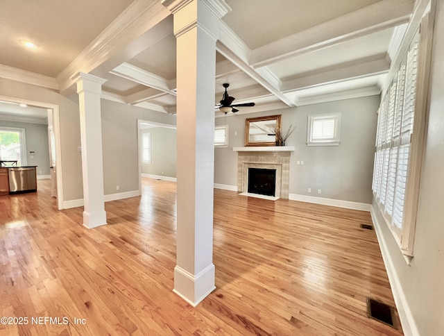 unfurnished living room featuring visible vents, light wood-style floors, ceiling fan, and decorative columns