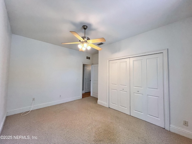 unfurnished bedroom featuring a closet, visible vents, baseboards, and carpet