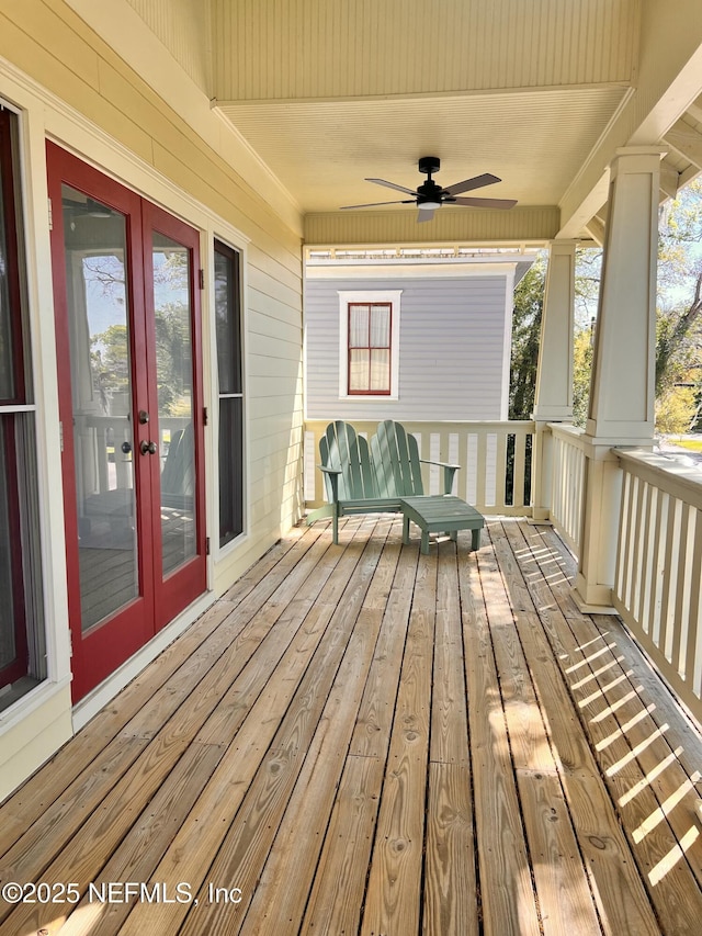wooden terrace featuring french doors and ceiling fan