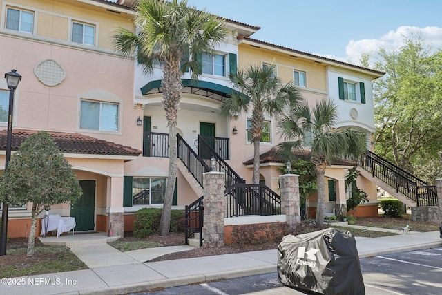 9745 Touchton Rd Unit 1629, Jacksonville, FL 32246 - view of property with uncovered parking and stairs
