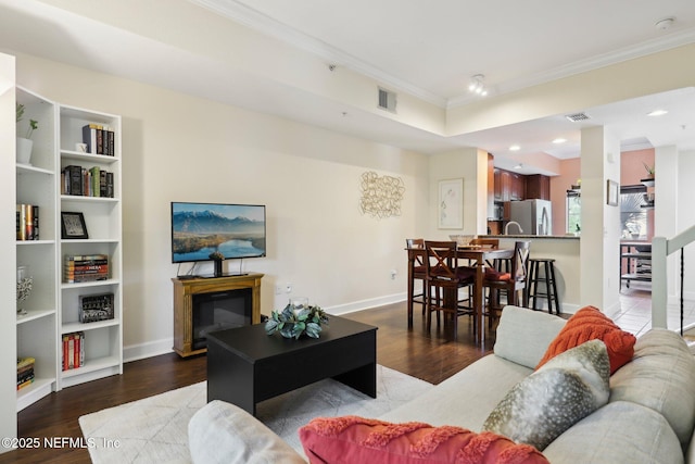 9745 Touchton Rd Unit 1629, Jacksonville, FL 32246 - living area with crown molding, visible vents, baseboards, and wood finished floors