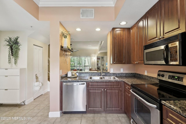 9745 Touchton Rd Unit 1629, Jacksonville, FL 32246 - kitchen with visible vents, a sink, appliances with stainless steel finishes, crown molding, and dark stone counters