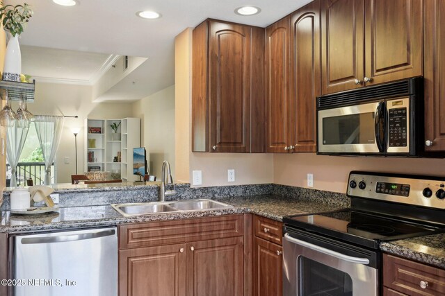 9745 Touchton Rd Unit 1629, Jacksonville, FL 32246 - kitchen featuring crown molding, recessed lighting, dark stone countertops, a sink, and stainless steel appliances