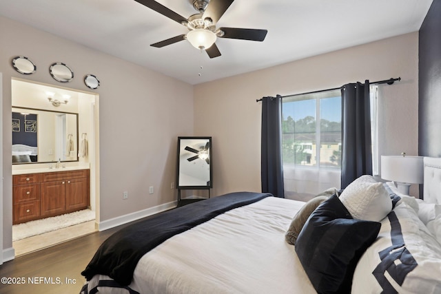 9745 Touchton Rd Unit 1629, Jacksonville, FL 32246 - bedroom featuring connected bathroom, a ceiling fan, a sink, baseboards, and dark wood-style floors