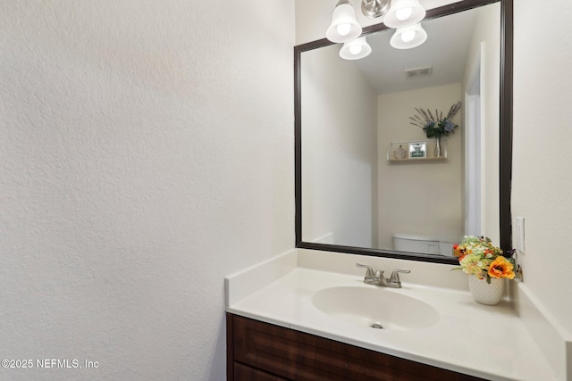 9745 Touchton Rd Unit 1629, Jacksonville, FL 32246 - bathroom with visible vents, toilet, vanity, and a notable chandelier