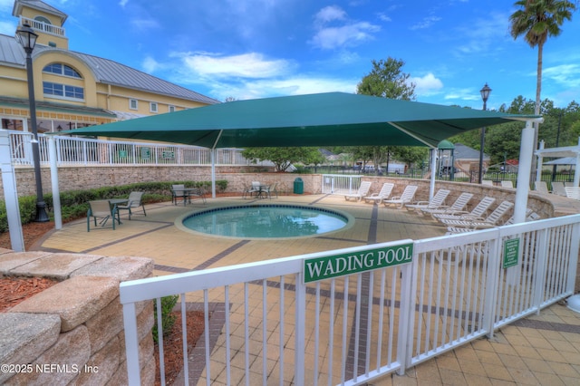 pool featuring a patio and fence