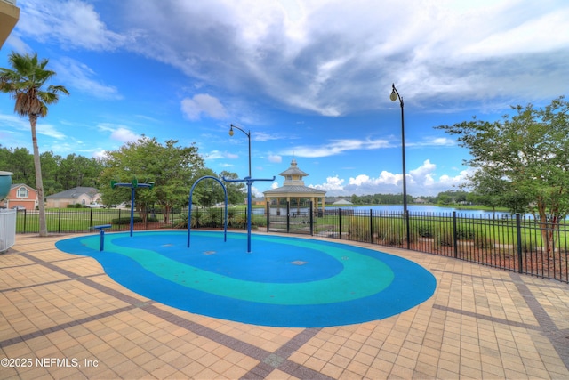 view of pool with fence, a gazebo, a water view, and a patio area