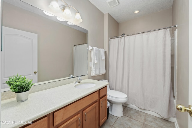 bathroom with a textured ceiling, visible vents, tile patterned flooring, vanity, and toilet