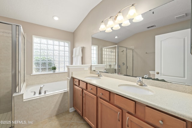full bathroom featuring a garden tub, a sink, a stall shower, and vaulted ceiling