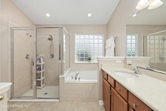 full bath with a wealth of natural light, a garden tub, and a stall shower