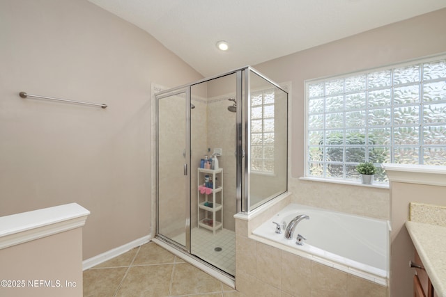 full bath featuring tile patterned flooring, a bath, vaulted ceiling, and a shower stall