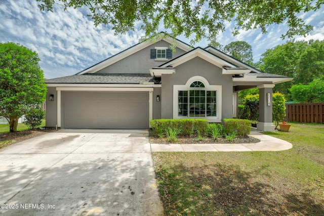 single story home with a garage, fence, a front lawn, concrete driveway, and stucco siding