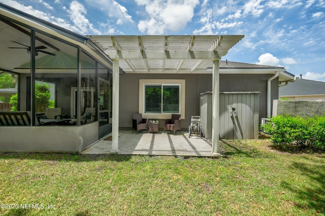 rear view of property featuring a pergola, a patio, stucco siding, an outdoor hangout area, and a yard