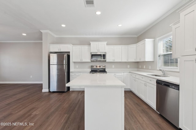 2939 Fitzgerald St, Jacksonville, FL 32254 - kitchen featuring crown molding, stainless steel appliances, a center island, a sink, and visible vents