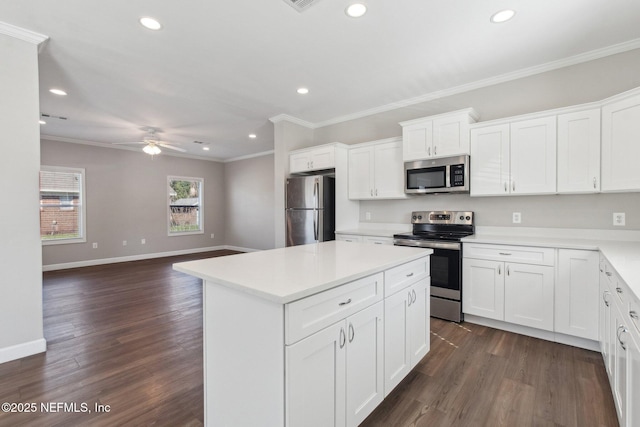 2939 Fitzgerald St, Jacksonville, FL 32254 - kitchen with dark wood-style flooring, ornamental molding, and appliances with stainless steel finishes