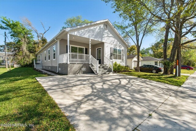 2939 Fitzgerald St, Jacksonville, FL 32254 - view of front of home with a front lawn, driveway, and covered porch