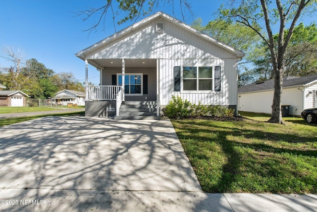 2939 Fitzgerald St, Jacksonville, FL 32254 - bungalow-style home featuring covered porch, a front lawn, and concrete driveway