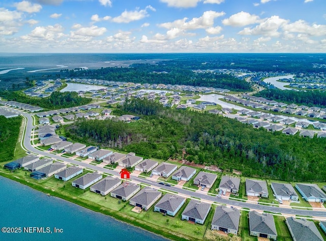 drone / aerial view featuring a residential view and a water view