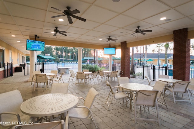 view of patio / terrace featuring fence, ceiling fan, and outdoor dining area