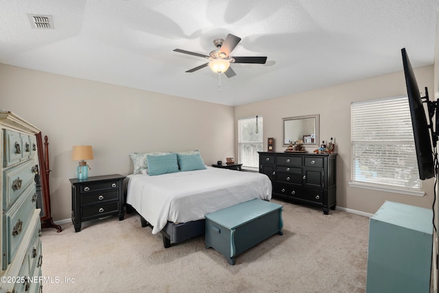 bedroom featuring light carpet, baseboards, and ceiling fan