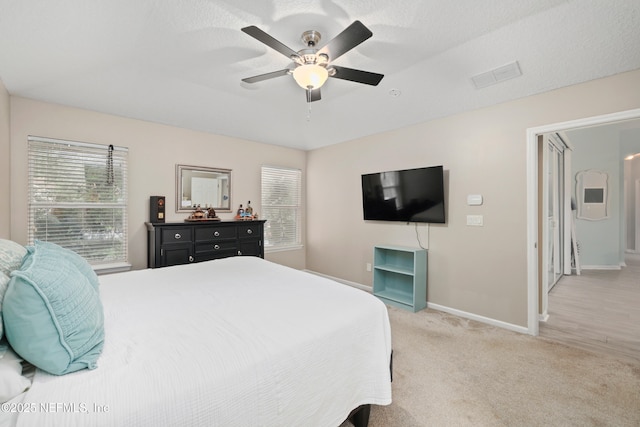 bedroom with baseboards, light carpet, and ceiling fan