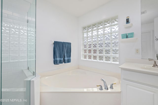 bathroom featuring a bath, vanity, and a stall shower