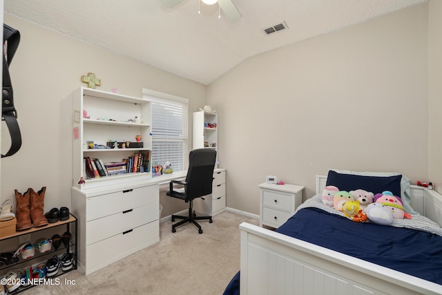 bedroom with light colored carpet, vaulted ceiling, and a ceiling fan