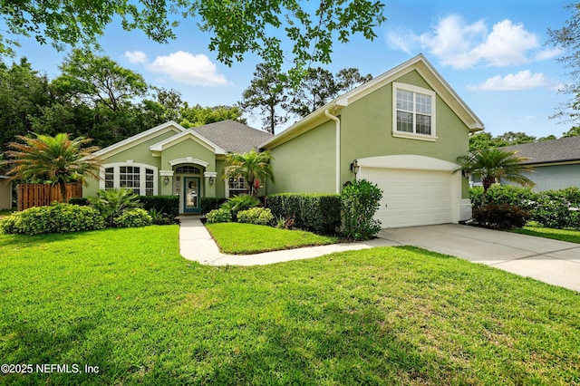view of front of property featuring an attached garage, stucco siding, a front lawn, and driveway