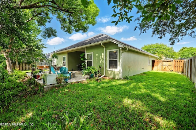 back of property featuring a patio and a gate