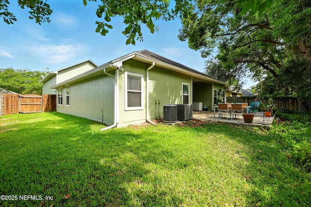 rear view of house with central AC, a patio, and a gate
