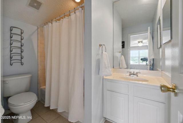 bathroom featuring tile patterned flooring, toilet, and vanity