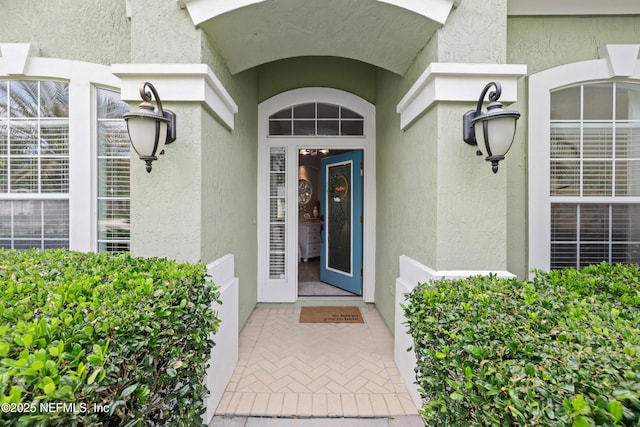 entrance to property with stucco siding