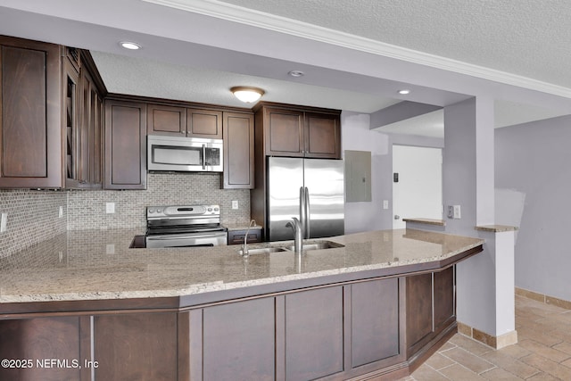 2200 Ocean Dr Unit 4A, Jacksonville Beach, FL 32050 - kitchen with a sink, light stone countertops, stainless steel appliances, and a peninsula