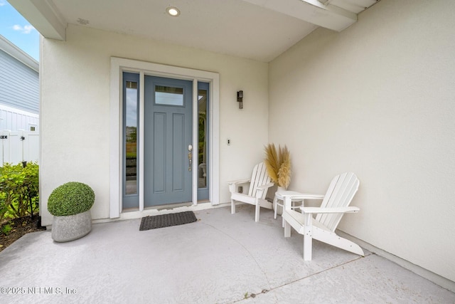 property entrance featuring stucco siding