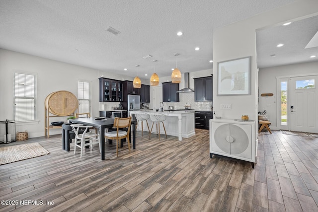 interior space with wood finished floors, recessed lighting, and visible vents