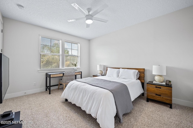 carpeted bedroom featuring baseboards, ceiling fan, and a textured ceiling