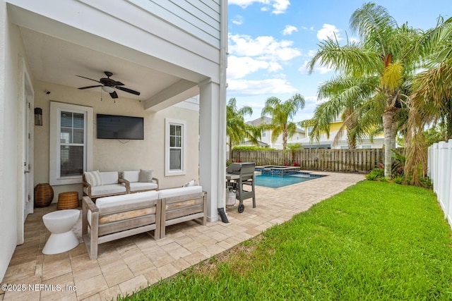 view of patio with outdoor lounge area, a pool with connected hot tub, a fenced backyard, and ceiling fan