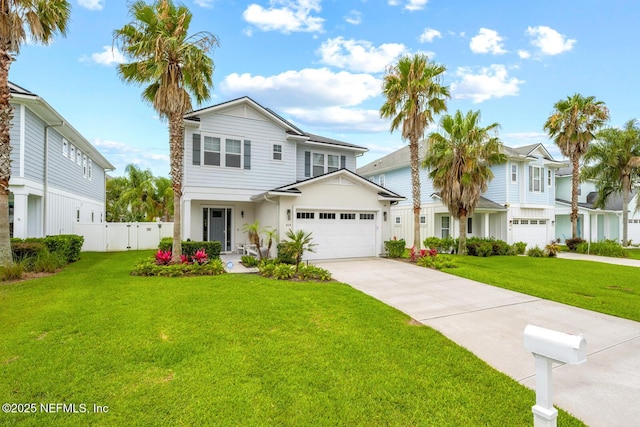 view of front facade with a front lawn, driveway, and fence