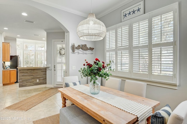 96064 Bottlebrush Ln, Fernandina Beach, FL 32034 - dining area with visible vents, light tile patterned flooring, recessed lighting, arched walkways, and crown molding