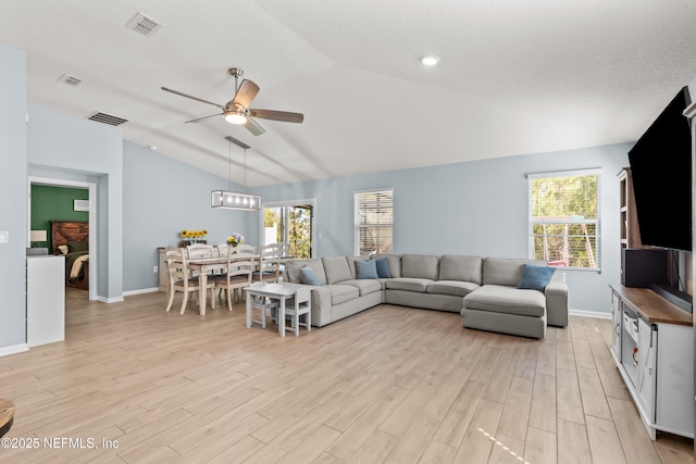 208 Seville Pkwy, Saint Augustine, FL 32086 - living area featuring a ceiling fan, light wood finished floors, vaulted ceiling, and visible vents