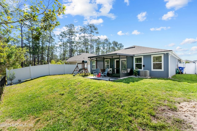 208 Seville Pkwy, Saint Augustine, FL 32086 - back of property with a sunroom, a patio, a fenced backyard, central AC, and a lawn