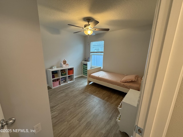 208 Seville Pkwy, Saint Augustine, FL 32086 - bedroom featuring a textured ceiling, dark wood-type flooring, and ceiling fan