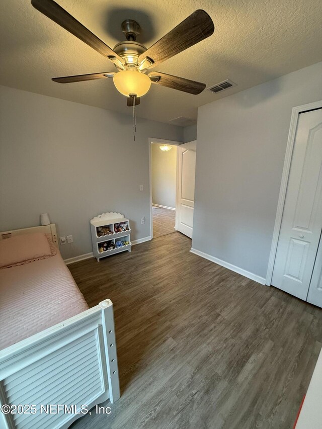 208 Seville Pkwy, Saint Augustine, FL 32086 - bedroom with wood finished floors, a textured ceiling, and a ceiling fan