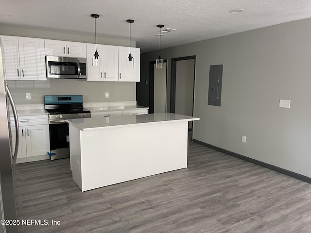1517 W 33rd Rd, St, Jacksonville, FL 32209 - kitchen featuring light countertops, white cabinets, electric panel, and appliances with stainless steel finishes